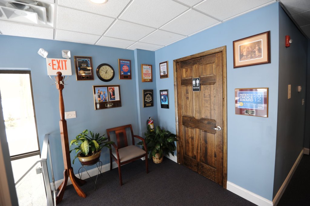 Near the front desk restrooms and coat rack