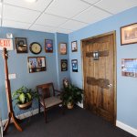 Near the front desk restrooms and coat rack